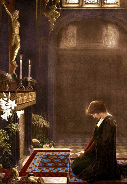 Woman praying before Crucifix
